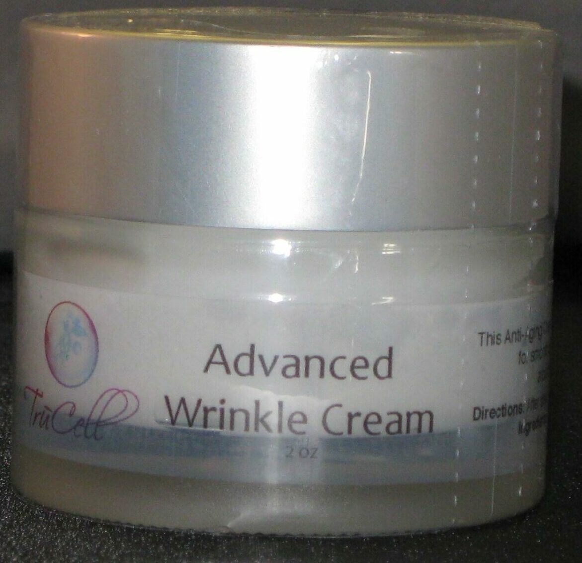 A jar of advanced wrinkle cream on top of a table.